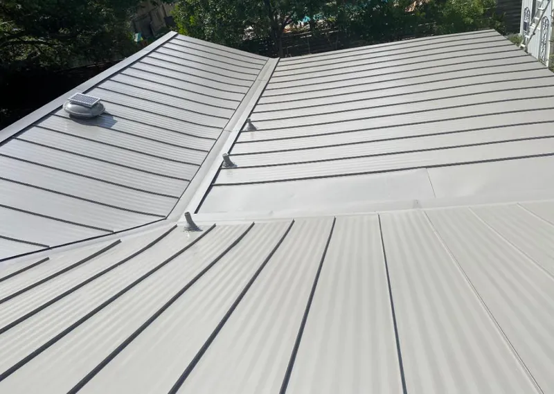 Solar attic fan installed on a metal roof for Roof Ventilation in Lely Resort